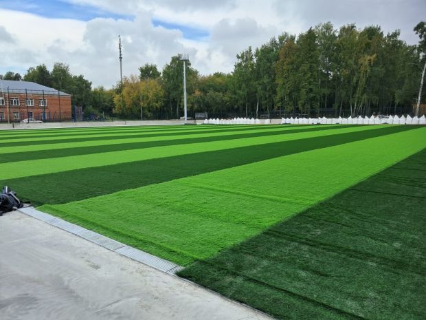 Искусственный газон укладывают на новом стадионе на ОбьГЭС